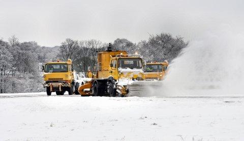 Snow ploughs battle to clear the runway at Leeds Bradford Airport to enable flights to depart.