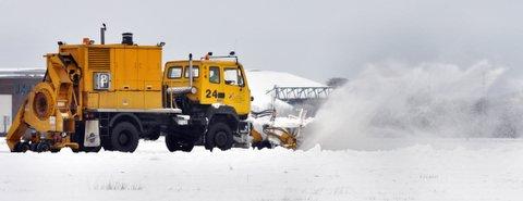 Snow ploughs battle to clear the runway at Leeds Bradford Airport to enable flights to depart.