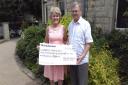 Anne Wells of Carers Resource receiving the cheque