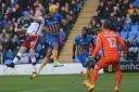 The impressive Ben Godfrey heads at goal for Shrewsbury against City – Picture: Mick Haynes