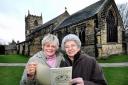 Dorothy Tinkler and Sybil Mussell with the Saints and Celebs Cookbook, at All Saints Parish Church, Ilkley