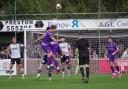 Match action from Guiseley (purple) and Bamber Bridge. Photo credit: Stefan Willoughby