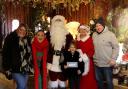 The Machell family with Santa and his elves at Otley Garden Centre