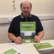Councillor Adrian Naylor with a copy of Addingham's Neighbourhood Plan