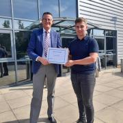 Oliver Gregory, Group Head of HR at Spooners Industries presents the award and certificate to Liam Jolly