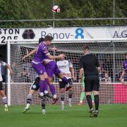 Match action from Guiseley (purple) and Bamber Bridge. Photo credit: Stefan Willoughby