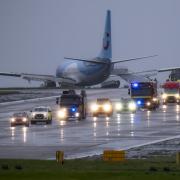 Emergency services at the scene after a passenger plane came off the runway at Leeds Bradford Airport while landing in windy conditions during Storm Babet earlier this year