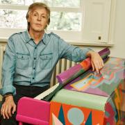 Paul McCartney sat at the ‘Magic Piano’ that was painted by Dudley Edwards © Mary McCartney
