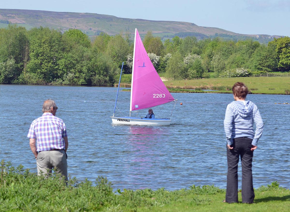 Show visitors enjoy the view over Weston Water in Otley