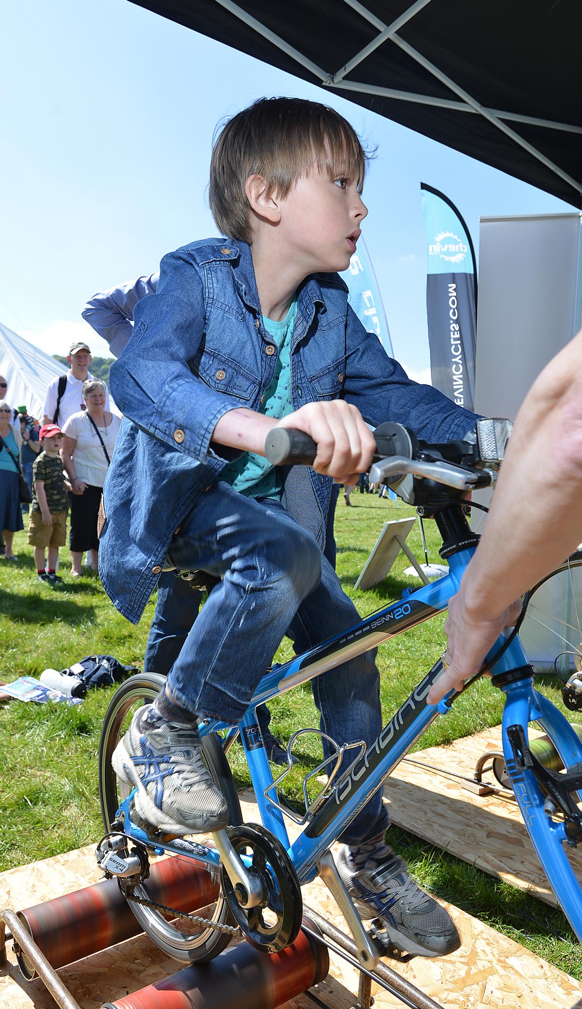 Hugo Dumont takes on his big sister at the cycling challenge at the Otley Cycle Club stand 