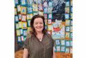 Alison Brown with the window display at the Grove Bookshop in Ilkley to celebrate Mothers' Day