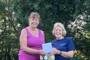 New Wharfedale Division Commissioner Karen Hill (L)  presenting a gift of thanks to retiring Commissioner Sue Vint (R)