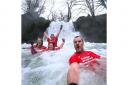 Stuart Gledhill and fellow brave dippers in Janet's Foss, Malham, on January 1.