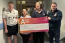 Cricket club representatives hand over the cheque at Airedale Hospital