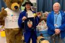 Retired guide dog Ben, with mascot Marty Bear, town cruyer Isabel Ashman and Ian Mallinson