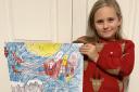 Evie is pictured with her winning design