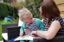 Sue O'Leary-Hall reading with her daughter Rose