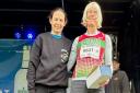 Hilda Coulsey receiving her age category prize from British long distance runner Jo Pavey MBE, at the Antrim Coast Half Marathon. Photo credit: Hilda Coulsey