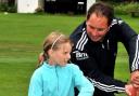 Andrew Jemmings gives advice to Rachel Scott, eight, during the summer school at Ben Rhydding Cricket Club.
