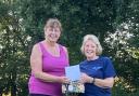 New Wharfedale Division Commissioner Karen Hill (L)  presenting a gift of thanks to retiring Commissioner Sue Vint (R)