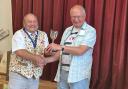 Phil Gomersall, President of the National Allotments Society presents a trophy to Jeff Walbank who received four trophies in total
