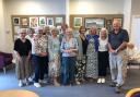 Members of the Monday art class at the Clarke Foley Centre in Ilkley, in front of their exhibition