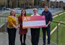 Airedale Hospital & Community Charity team with members of ILTSC at a cheque presentation for the 80s Disco fundraiser