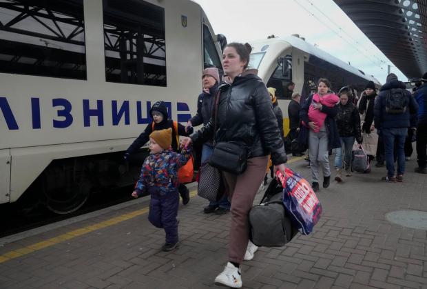 Ilkley Gazette: Ukrainian refugees at a train station. Credit: PA