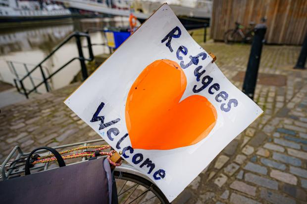 Ilkley Gazette: Refugees welcome sign. Credit: PA