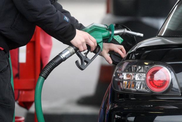 Ilkley Gazette: Someone using a fuel pump at a petrol station (PA)
