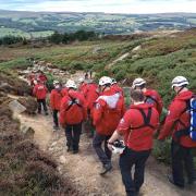 The team carrying the casualty off Ilkley Moor. Picture UWFRA