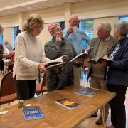 The Ilkley artists are pictured discussing the recently produced books by the Otley writers