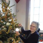 Adding stars to the tree in Addingham Methodist Church
