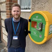 Guiseley and Rawdon Councillor, Paul Alderson with the new defibrillator at Greenacre Hall in Rawdon