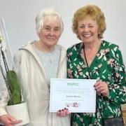 Eleanor Monks is presented with her certificate by secretary of Wharfedale NSPCC, Diane Smith