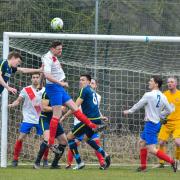 Pool's Josh Waite (white shirt) strains to win this header Picture: Andy Garbutt