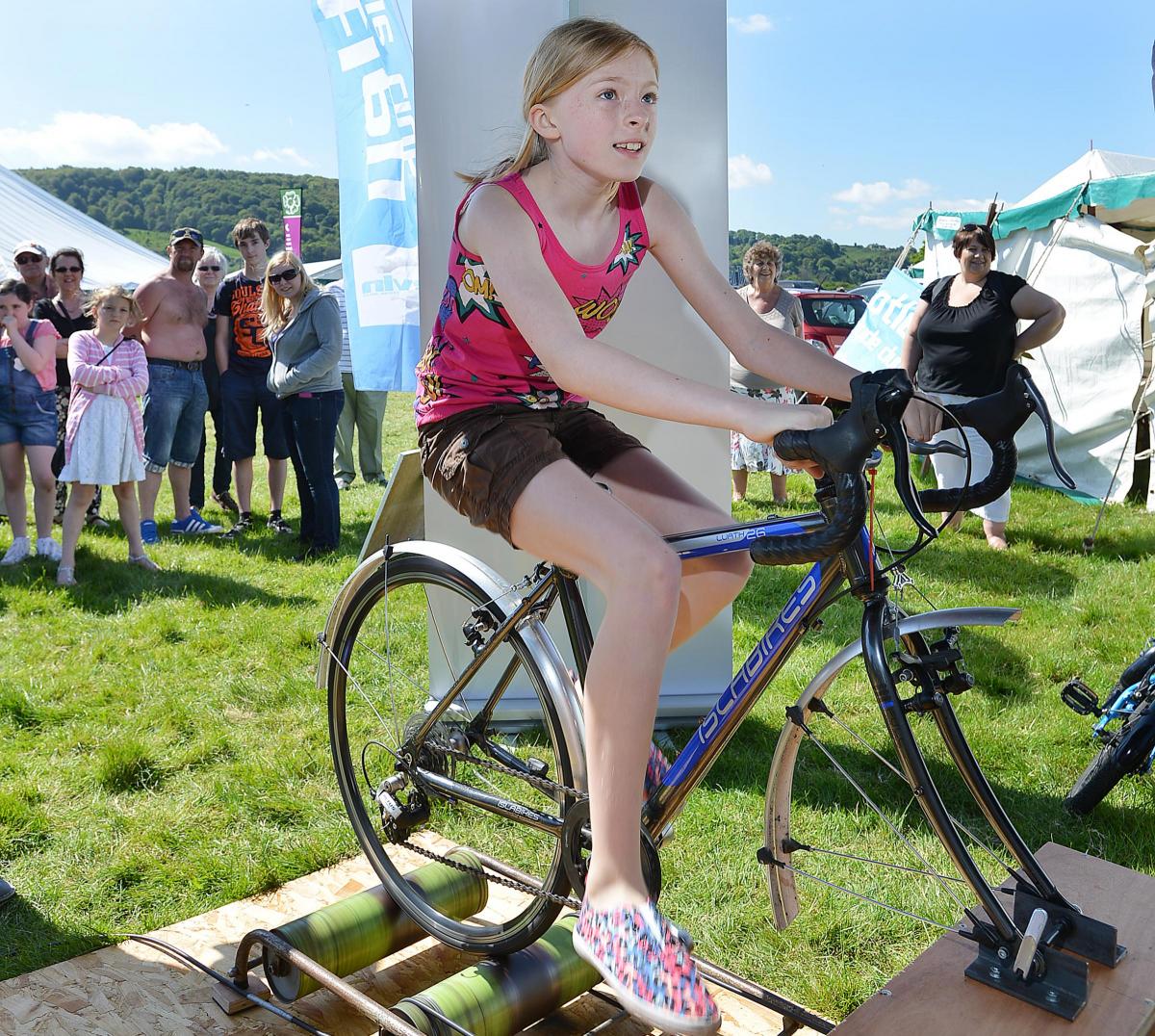 Sadie Dumont challenges her brother Hugo to a cycling duel at  the Otley Cycle Club stand.