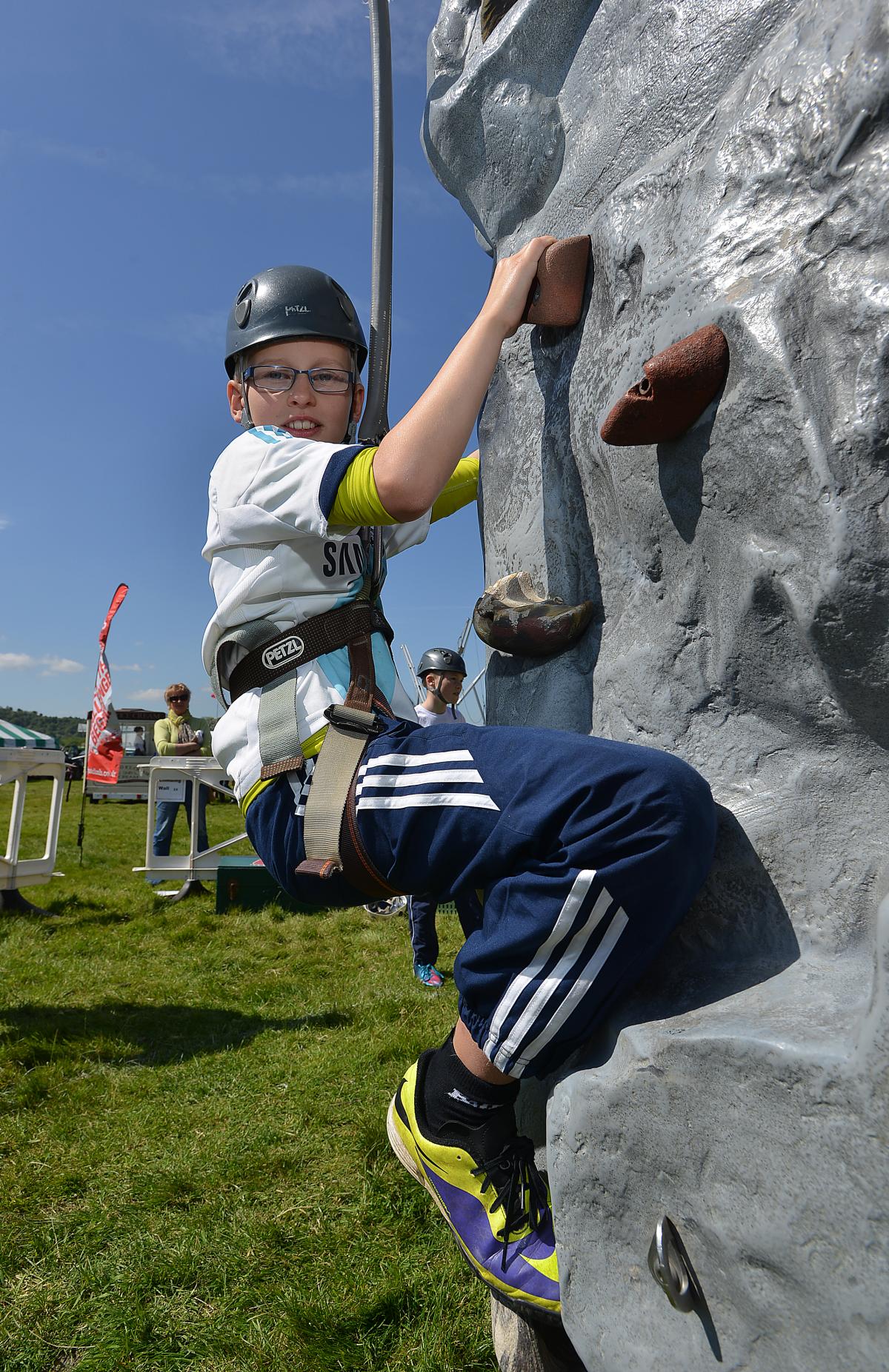 Tackling the climbing wall for the first time is Josh Brown, ten